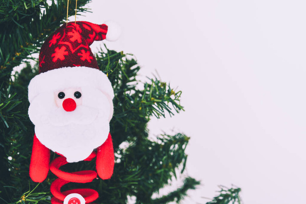 felt Santa Claus doll hanging on Christmas tree, white background, copy space - Photo, Image