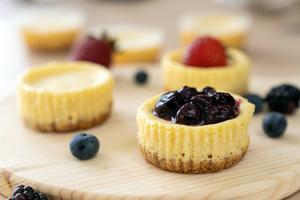 Mini cheesecake decorated with blueberry, blackberry and strawberry - Photo, Image