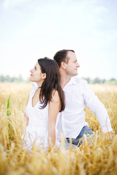 Young couple have a rest in the summer field - Foto, Imagem
