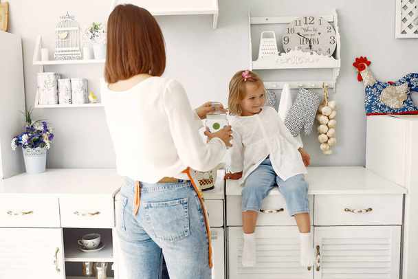 Mother with little daughter having fun at home - Foto, imagen