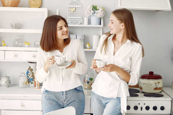 Two girlfriends drinking tea at home - Valokuva, kuva