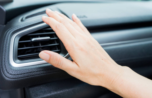 Closeup of hand checking the air conditioner system in the car. - Foto, imagen