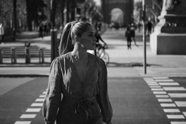 Retrato de una joven mujer hermosa cruzando con confianza la calle. Foto en blanco y negro
 - Foto, Imagen