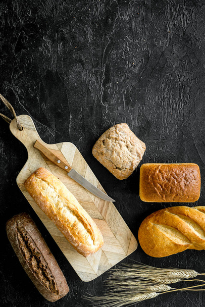 Loaf of bread on cutting board top-down copy space - Фото, изображение