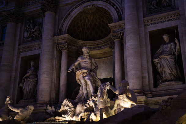 The famous Trevi Fountain illuminated by its night lighting in Rome, Italy - Фото, изображение