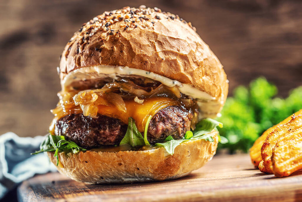 Beef burger with caramelized onion, arugula and melted cheese - Фото, зображення