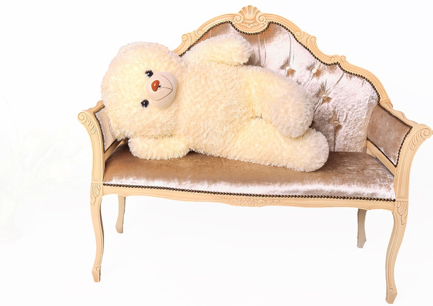 Teddy bear lying on a bench - Fotó, kép