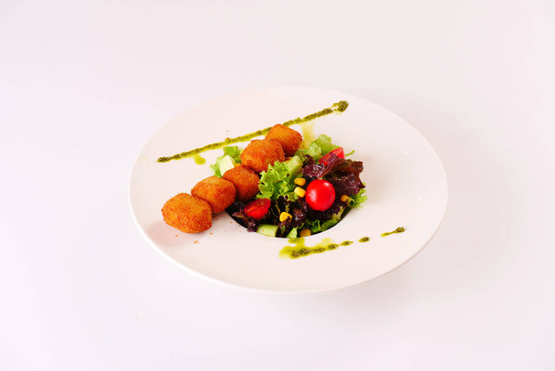 Cheese croquettes served with lettuce, tomatoes. White background - Fotó, kép