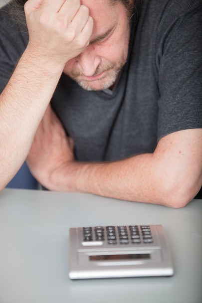 Depressed man doing his finances - Valokuva, kuva