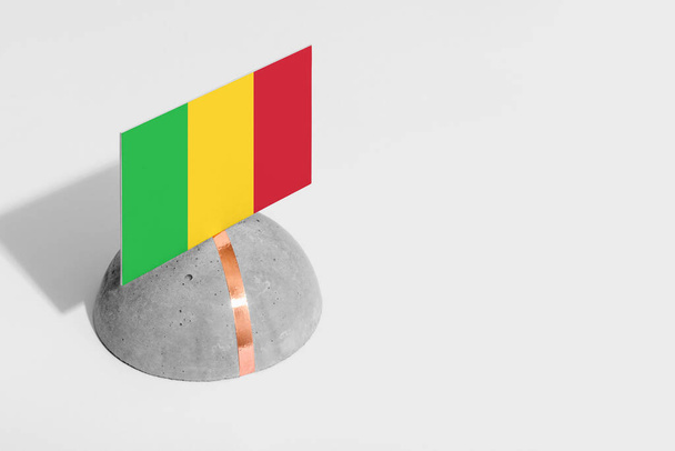 Mali flag tagged on rounded stone. White isolated background. Side view minimal national concept. - Photo, Image