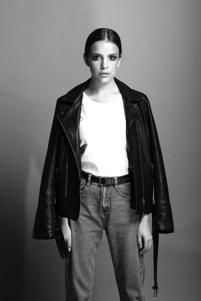 black and white portrait of  girl with big eyes, in  leather jacket and jeans - Foto, Imagem