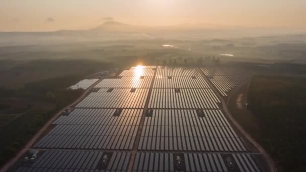 Footage B Roll of Aerial view  drone Hyperlapse Timelapse Solar cell farm at sunrise morning. Solar power plants have foggy moving slow motion through and sunlight shines on solar cell. B Roll scene. - Footage, Video