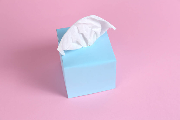 Box with paper tissues on pink background - Foto, Imagen