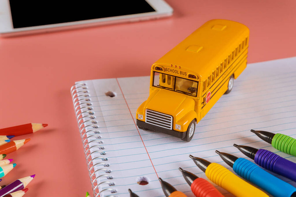 Back to school concept with bus and notebook colored pencils - 写真・画像