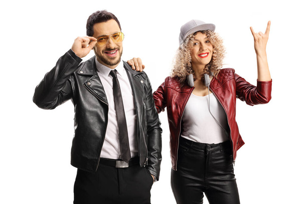 Young couple gesturing a rock and roll sign isolated on white background - Φωτογραφία, εικόνα