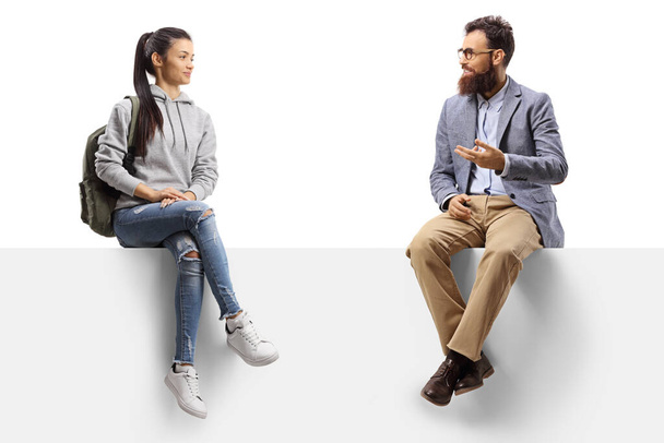 Female student sitting on a panel and talking with a bearded man isolated on white background - Foto, Bild