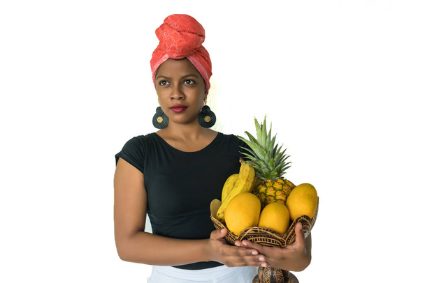 African woman holding a basket of fruits on an isolated white background for cut out - Photo, Image