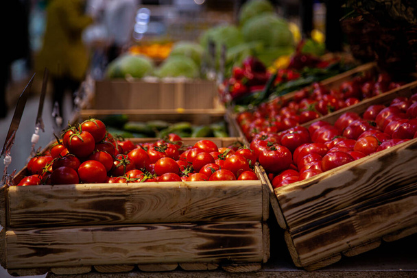 Red cherry tomatoes in wooden trays - Fotoğraf, Görsel