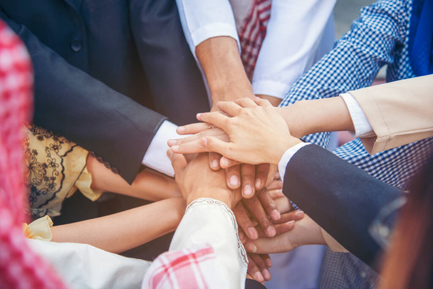 Group of people diversity multiethnic teamwork collaboration team meeting communication  Unified team concept. Business people hands together diversity multiethnic diverse culture partner team meeting - Photo, Image
