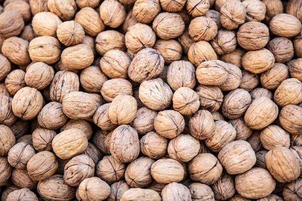 Walnuts with and without shells (filling the picture). Background of fresh walnuts.  - Photo, Image