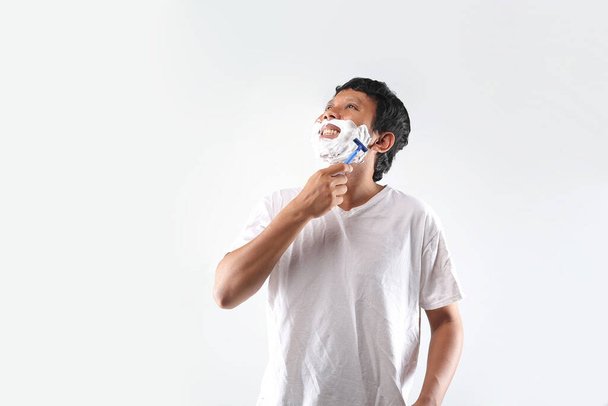 man shaving face. young man shaving - Photo, Image