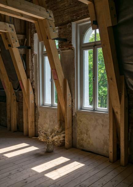 picture with wooden beams and windows in the roof attic, view out the window - Photo, Image