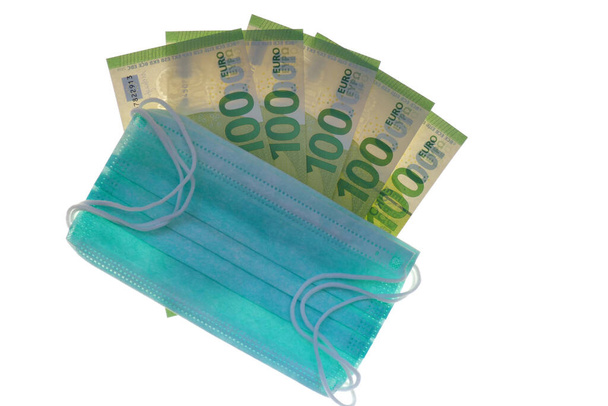 Conjunto de máscaras protectoras médicas y billetes en euros aislados sobre fondo blanco
 - Foto, imagen
