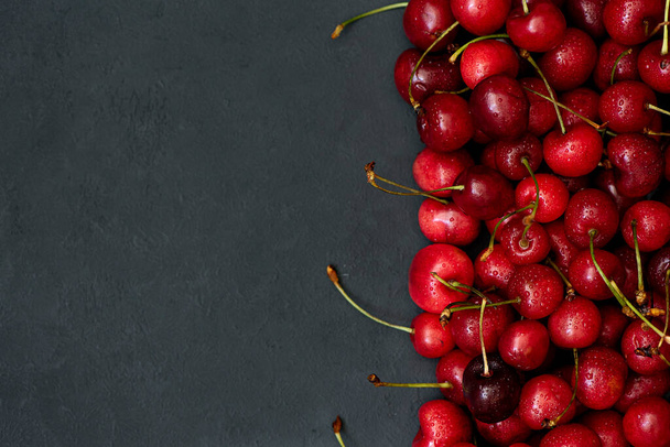 black background with ripe sweet red cherries - Photo, Image