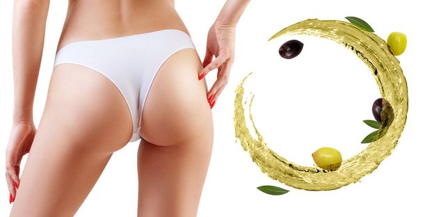 Female buttocks near olive oil circulation. Slimming concept. - Photo, Image