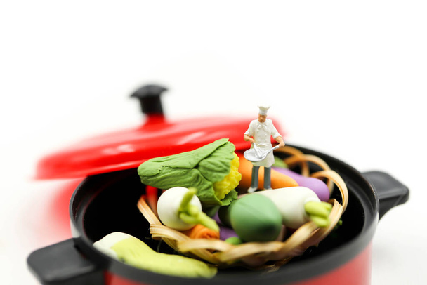 Miniature people : Chef cooking fresh vegetables in a pot - Fotó, kép