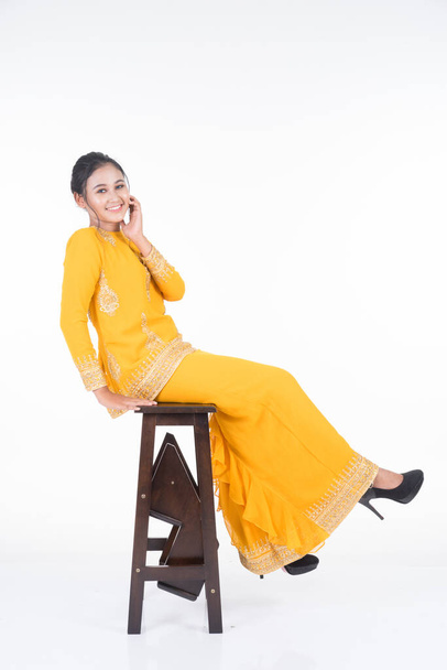 Beautiful female Asian model in various poses wearing modern kurung, a Malaysian traditional wear isolated on white background. Beauty and fashion concept. Full length portrait - Foto, afbeelding