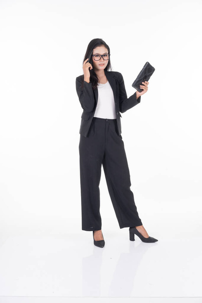 An attractive woman wearing business attire holding a tablet with various poses isolated on white background. Suitable for image cut out and manipulation works for technology,business or finance theme - Foto, afbeelding