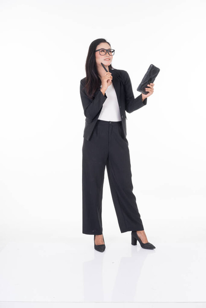 An attractive woman wearing business attire holding a tablet with various poses isolated on white background. Suitable for image cut out and manipulation works for technology,business or finance theme - Fotoğraf, Görsel