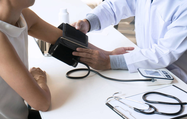 Arzt überprüft den arteriellen Blutdruck einer alten Patientin. Gesundheitsversorgung - Foto, Bild