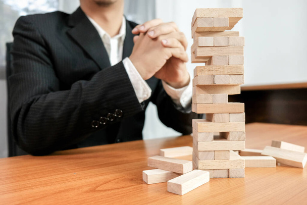 Planning risk and strategy in businessman gambling placing wooden block.Business concept for growth success process. - Fotoğraf, Görsel