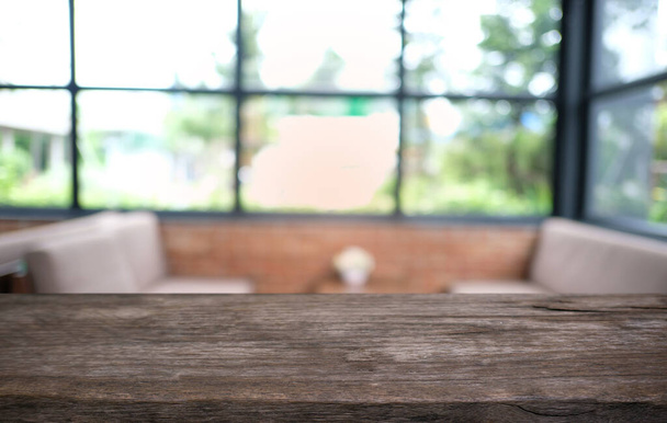 Leerer dunkler Holztisch vor abstrakt verschwommenem Bokeh-Hintergrund eines Restaurants. kann zur Anzeige oder Montage Ihrer Produkte verwendet werden. Mock up for space - Foto, Bild