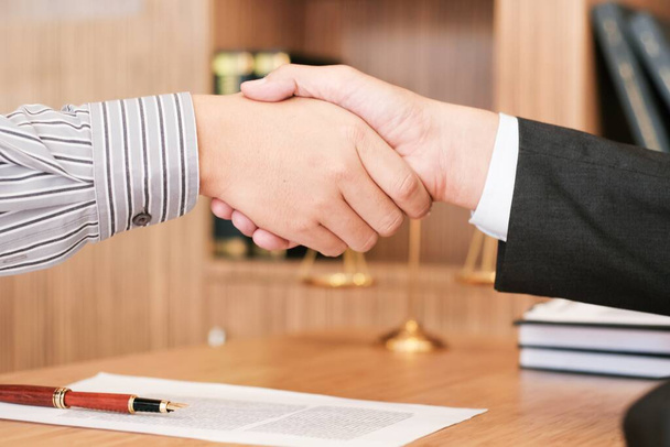 Female lawyer handshake with client. Business partnership meeting successful concept - Photo, Image