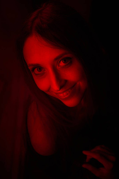 Girl lit in red. Passion, sensuality concept. - Valokuva, kuva