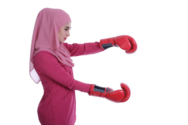 Pretty muslim woman using boxing glove with expression face style.  - Zdjęcie, obraz