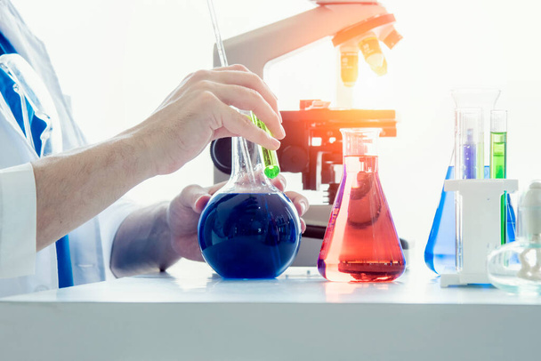 Scientist or medical in lab coat holding test tube , Laboratory glassware containing chemical liquid - Foto, Imagen