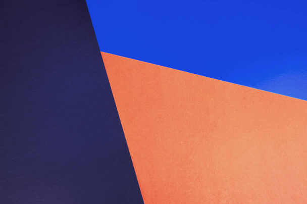 Abstract colored paper backgrounds with copy space. Navy, orange and blue colors.  Diagonal geometric composition in dark tones. Top view, flat lay. - Photo, Image