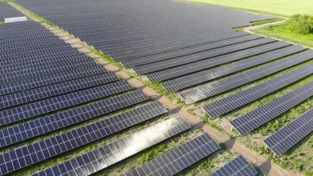 Big power plant with blue solar panels. View from drone. Blue panels stands in row on the ground . Free electricity for home. Sustainability of planet. Green energy. Solar cells power plant business. - Footage, Video