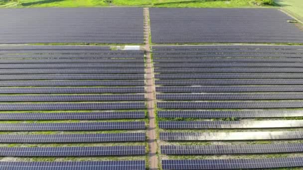 Big power plant with blue solar panels. View from drone. Blue panels stands in row on the ground . Free electricity for home. Sustainability of planet. Green energy. Solar cells power plant business. - Footage, Video
