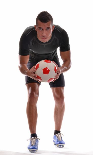 Soccer player holding a soccer ball. - Foto, afbeelding