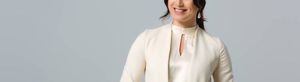 Panoramic crop of smiling businesswoman isolated on grey  - Foto, immagini