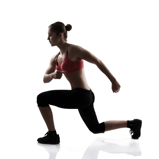 Athletic woman doing lunge - 写真・画像