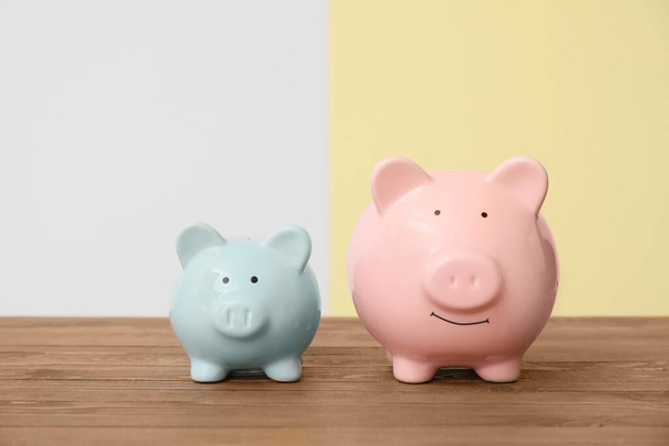 Piggy banks on table against light background - Photo, Image