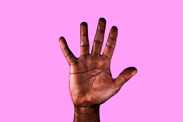 Open palm of a black man with spread fingers asking for stop racism isolated on pink background. - Photo, Image
