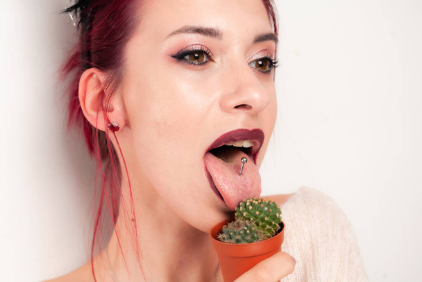 Funny girl licks a cactus. - Photo, Image