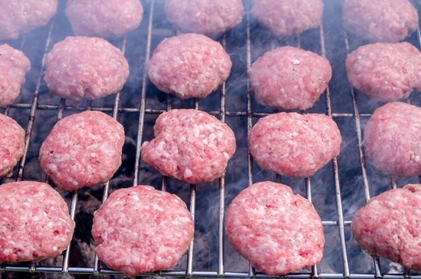 Grilling meatballs on the grill. Cooking  barbeque with charcoal in garden. Turkish cuisine. - Photo, image